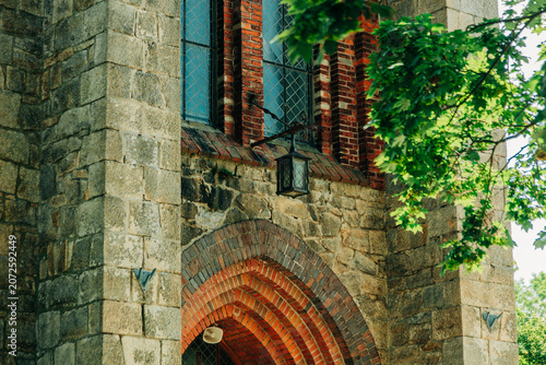 Lantern at entrance arch of 19th century Catholic Christian church, Europe.
