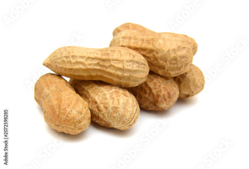 Dried peanuts in closeup on white