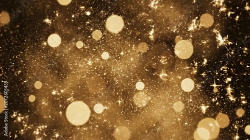 Golden glitter explosion with bokeh lights on black background