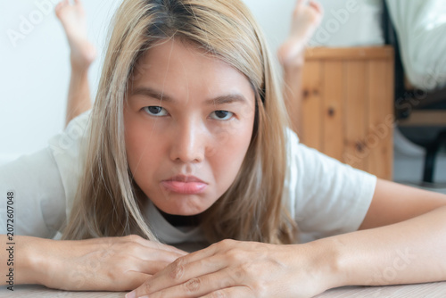 Tableau sur toile Funny Face of Unhappy Young Asian THai Woman Pouting with a Frustrated Expressio