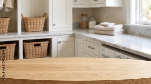 Empty oval wooden table top mockup for product display with blurred bright laundry room interior home background banner