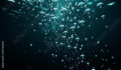 Underwater Bubbles Rising in Dark Blue Ocean Water