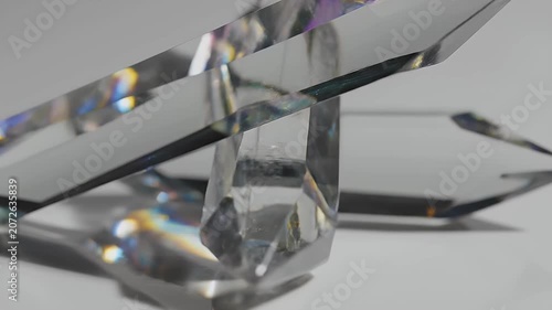 Close-up of a crystal glass sculpture with light reflections and refractions, creating a mesmerizing visual effect.