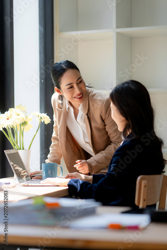 Businesswomen collaborating on a project during office meeting
