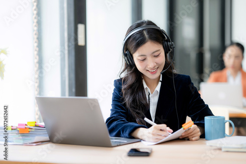 Asian call center worker providing online customer service