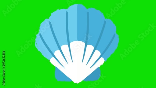 A large blue and white scallop shell sits on a green background. Day of Santiago in Spain.