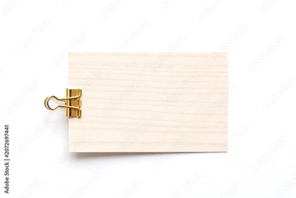 Fototapeta premium Wooden card with gold clip on white background
