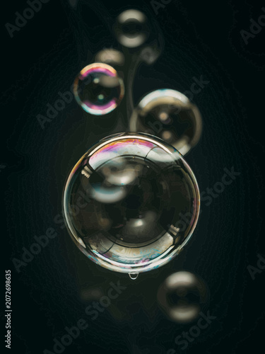 Large Soap Bubbles Floating on Dark Background