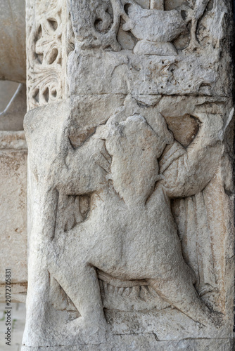 Close-up of medieval stone relief carved into the Romanesque portal of Basilica di San Nicola in Bari, Italy. Historic limestone sculpture showcasing intricate craftsmanship and artistic heritage