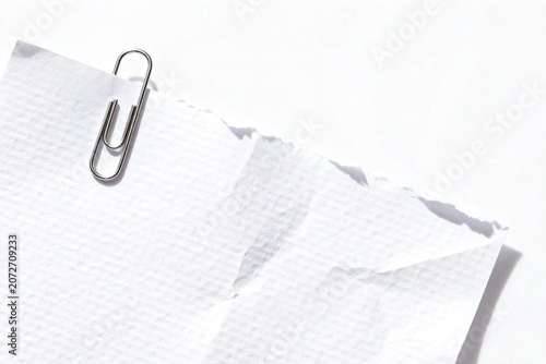 Torn Paper with Metal Clip on White Background