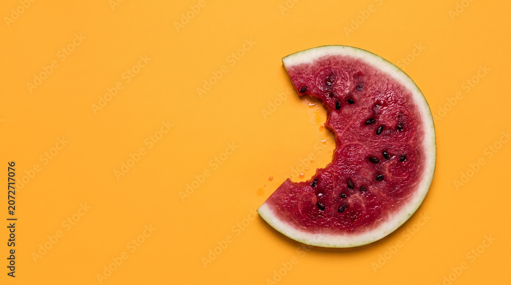 Fototapeta premium Fresh Bitten Watermelon Slice on Bright Yellow Background