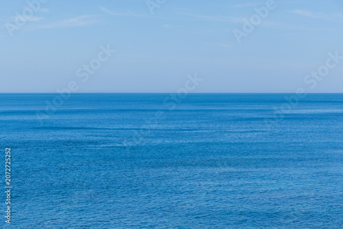 Bild auf Leinwand Calm blue sea water under clear sky