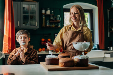 Mother and son baking Easter bread together in a warm kitchen