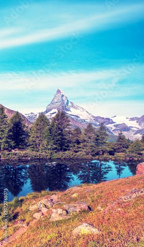 Matterhorn mountain rising above alpine lake and forests near Zermatt, Switzerland