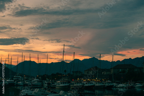 Beautiful sunset in Kotor bay. Old town and mountain in the background, very popular travel destination.