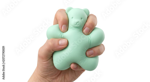 Foto Hand squeezing green bear shaped squishy toy on transparent background