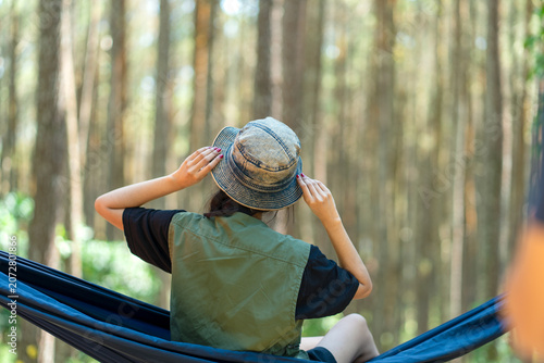 Rear View of Indonesian Woman Relaxing in Hammock Forest Camp