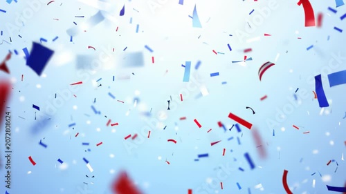 Vibrant red, white, and blue confetti falling against a clear sky background