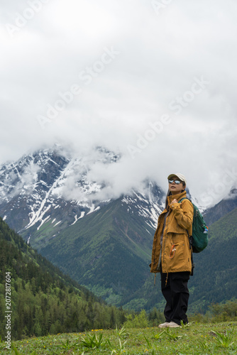 The young woman hiking in the valley