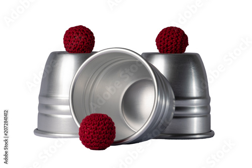 Fotografia Magic cups and red balls isolated on white