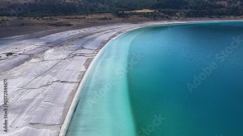 A wide-angle aerial view of Lake Salda’s turquoise waters and white mineral-rich shore