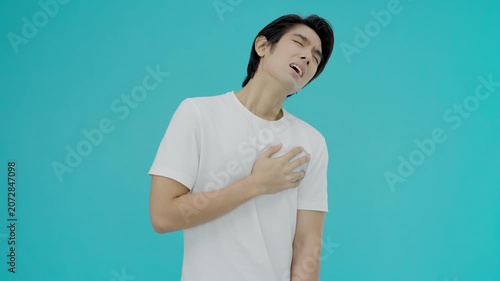 hand hold chest with heart attack symptoms, man have chest pain caused by heart disease, leak, dilatation, enlarged coronary heart, press on the chest with a painful expression