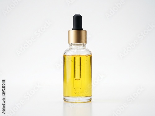 clear glass dropper bottle yellow liquid isolated white background
