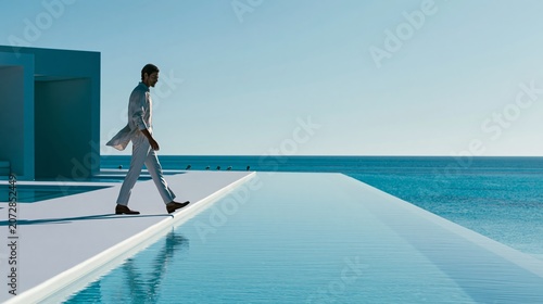 Elegant Male Model Walking Along Infinity Pool at Luxury Resort, Tropical Ocean Lifestyle Campaign with Cinematic Editorial Fashion Photography