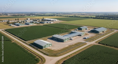Expansive Modern Agricultural Farm Complex Amidst Lush Green Fields Under a Clear Sky