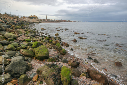 East end of Portobello beach in Edinburgh, overcast autumn day, Joppa parish church tower visible at distance