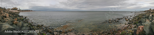 Panorama of east end of Portobello beach in Edinburgh, overcast autumn day, Joppa parish church tower visible at distance