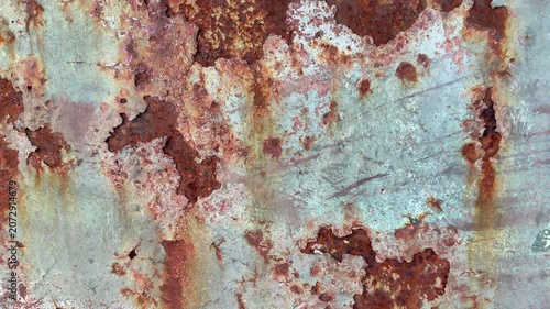 Background of paint flaking and rust panning shot movement wallpaper and abstract colour and surface.