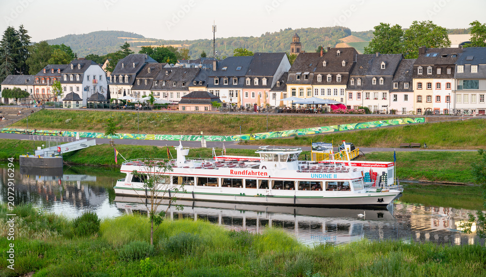 Fototapeta premium Excursion boats at Zurlauben riverbed in Trier, Germany, Moselle river and ancient roman city, Mosel valley landscape in summer, travel destination