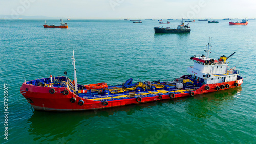 Canvas Print Side profile aerial drone shot of a colorful commercial supply vessel floating o