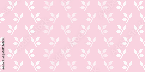 Seamless pink background with white cross-stitch floral pattern