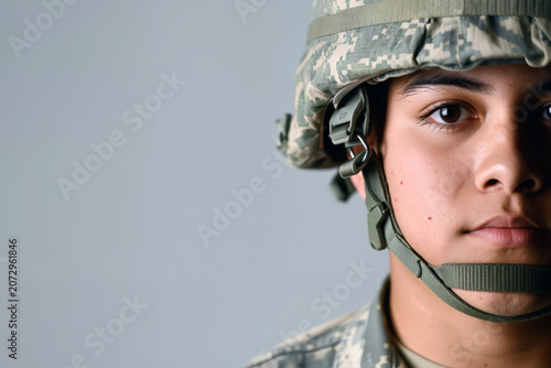 A young soldier stands confidently, wearing a camouflage uniform and helmet, focusing intently during an indoor military training session. Generative AI.