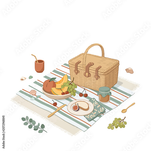 Picnic basket with food on blanket.
