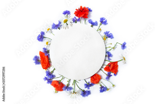 Beautiful floral frame with cornflowers, poppies and daisies on white background, top view