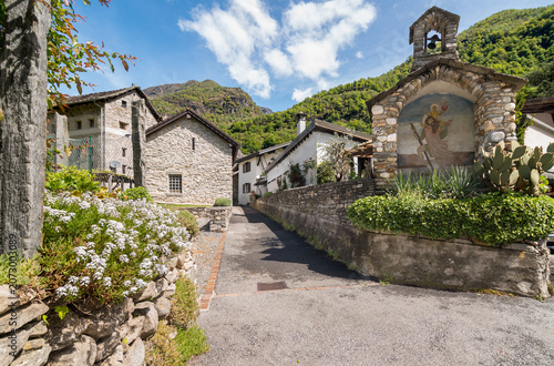A characteristic cobblestone street in a traditional village of the Maggia Valley, Canton of Ticino, Switzerland.