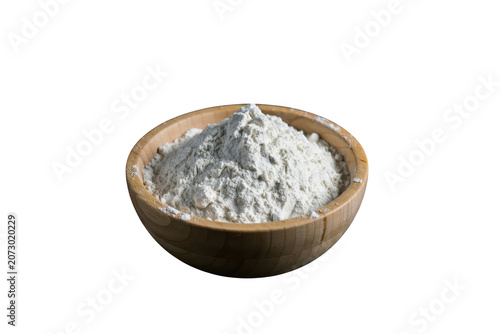 A wooden bowl filled with white wheat flour, isolated on a black background, showing fine texture and a heap of baking ingredient powder