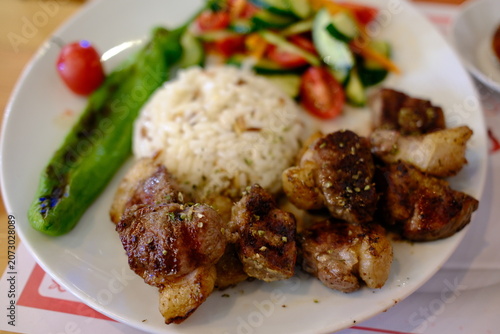 Картината върху платно Lamb şiş kebap with rice and vegetables, traditional Turkish food close-up