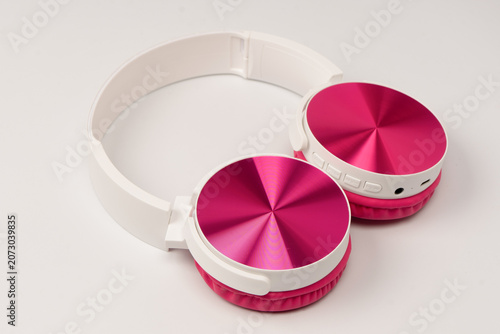 Pink and white headphones isolated on white background.