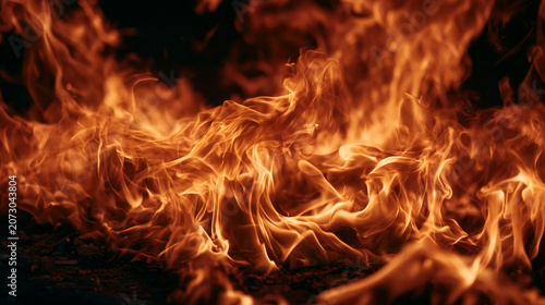Intense Fire Flames and Glowing Embers Burning in Dark Background
