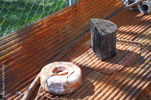 Rusted corrugated metal sheet with vintage industrial objects