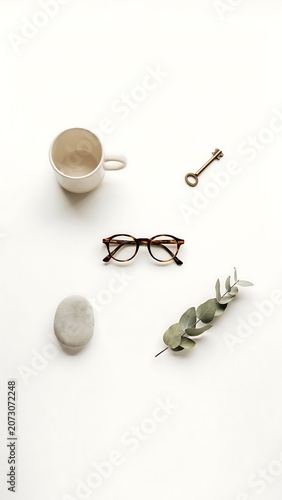 Vertical Minimalist Top View of Everyday Essentials on White Background Mockup.