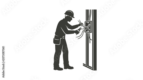 Electrician works carefully to install electrical wiring within a residential wall framing structure.