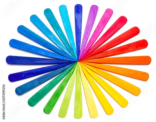 A circular arrangement of colorful, smooth, tapered objects radiating from a central point on a white background
