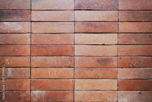 Obraz na plátně Terracotta brick wall texture with a horizontal running bond pattern and natural clay color variations