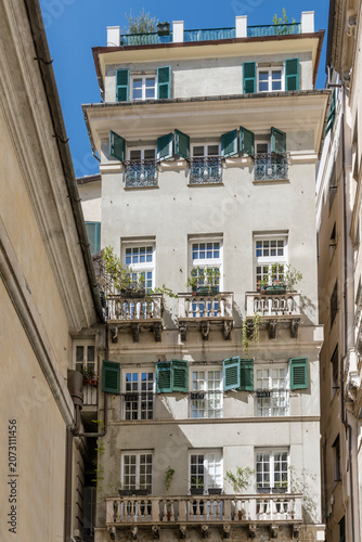 tall old building between narrow alleyways in central district, Genova