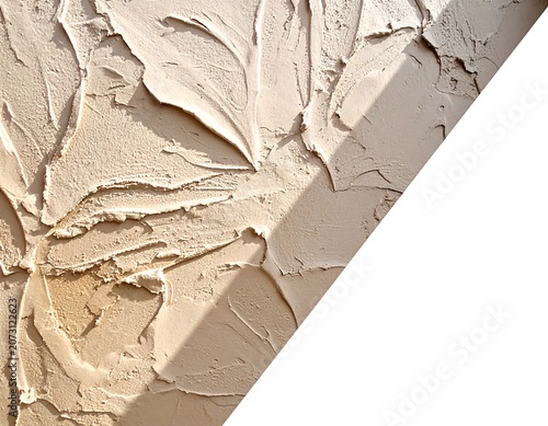 A close-up of a textured, beige-colored surface featuring raised, leaf-like patterns